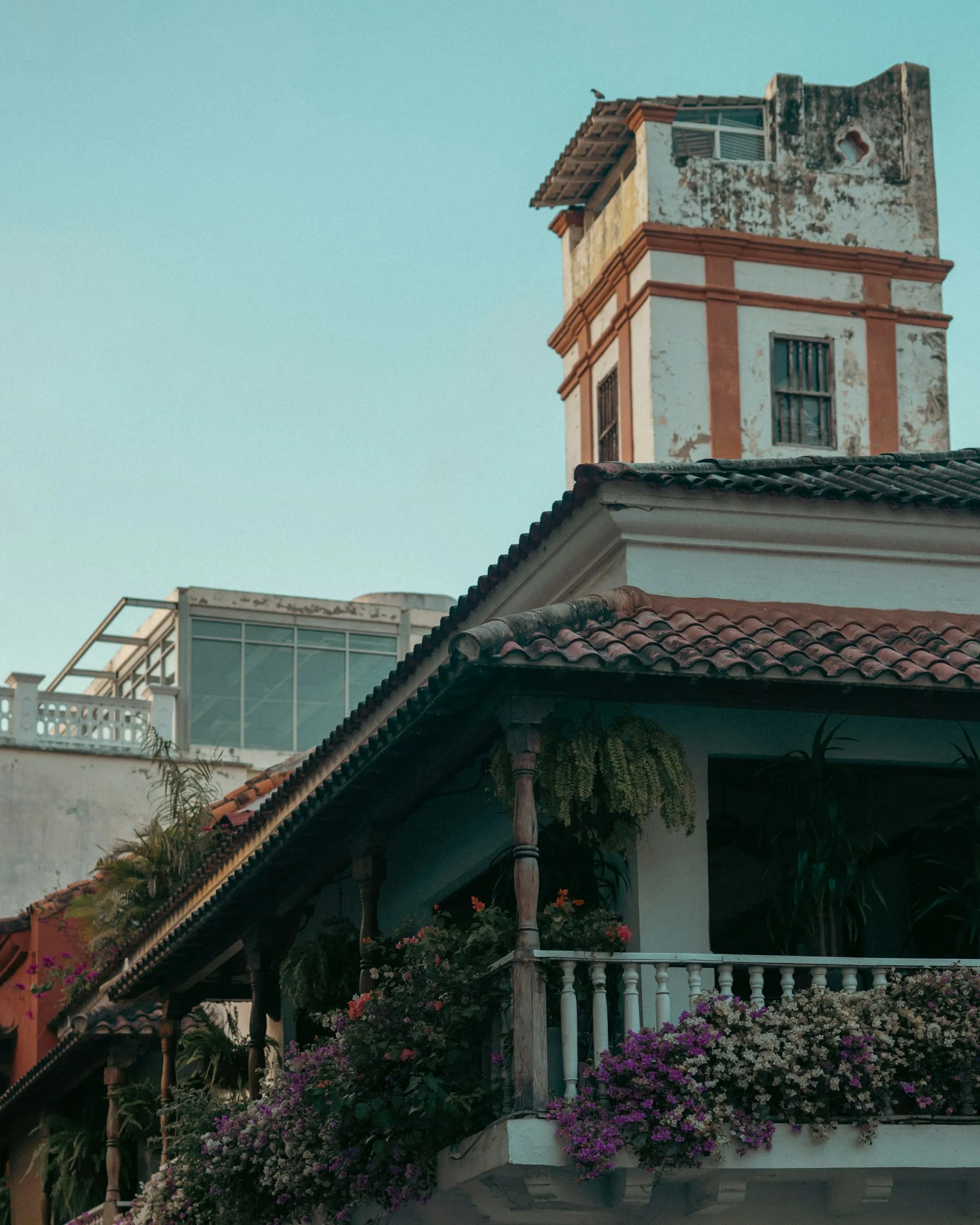 A colonial balcony overflowing with flowers