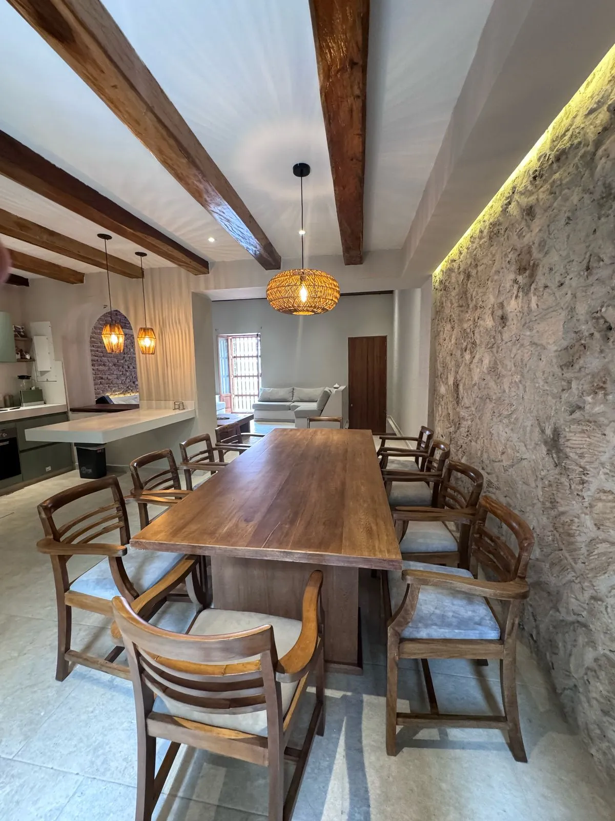 An elegant dining room with exposed stone and timber beams