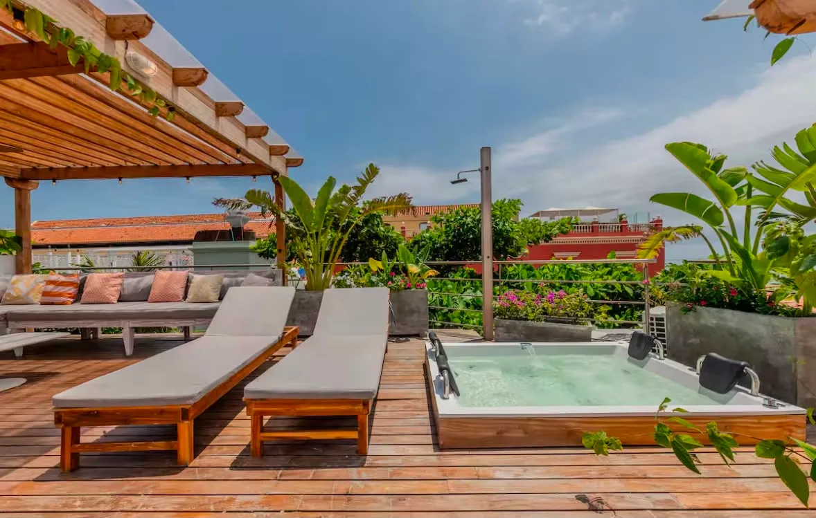 A private rooftop terrace with lounge chairs and a plunge pool overlooking Cartagena's old town